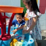 Children enjoying outdoor water play at East Bay, California preschool