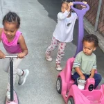 Children playing with ride-on toys at East Bay, California preschool