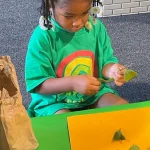Preschooler exploring nature at sensory table at East Bay, California preschool