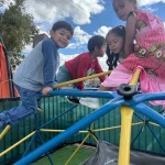 Preschoolers playing on outdoor climbing equipment at San Leandro, California preschool