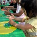 Toddlers working together on art project at East Bay, California preschool