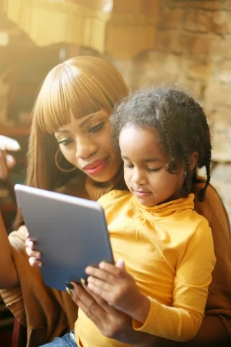 Mother and daughter using tablet together
